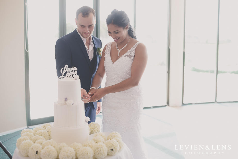 cake cutting - bride and groom reception details Formosa Golf Resort {Auckland wedding photographer}