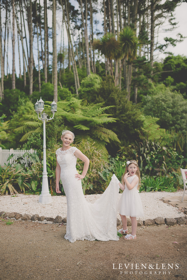 flower girl and stunning bride on bench {Auckland-Hamilton wedding photographer} Footbridge Lodge