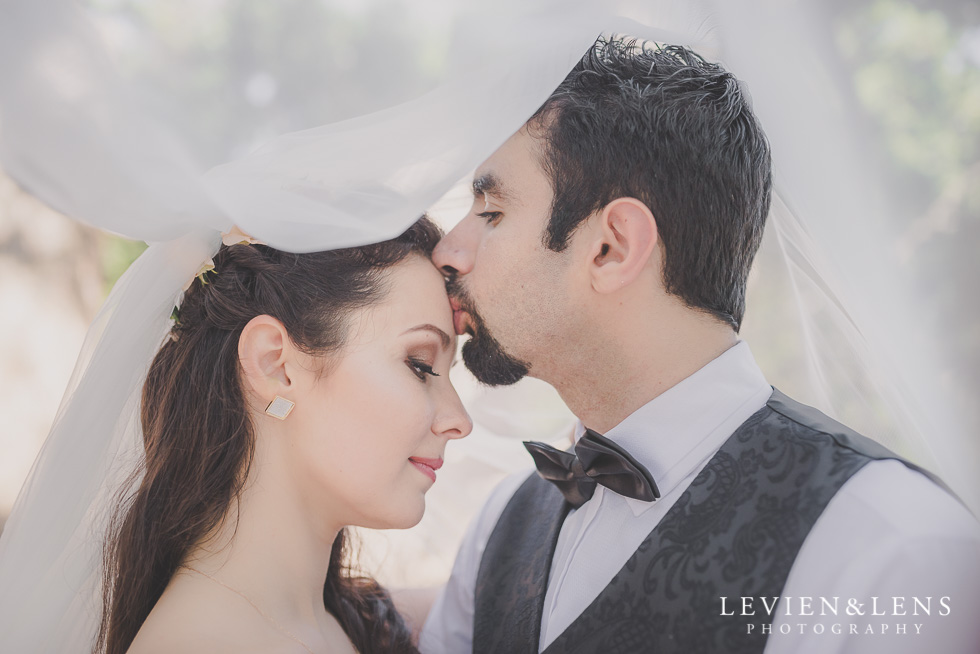 groom kiss bride forehead under vail Parnell on the Rose Garden {Auckland lifestyle wedding photographer}