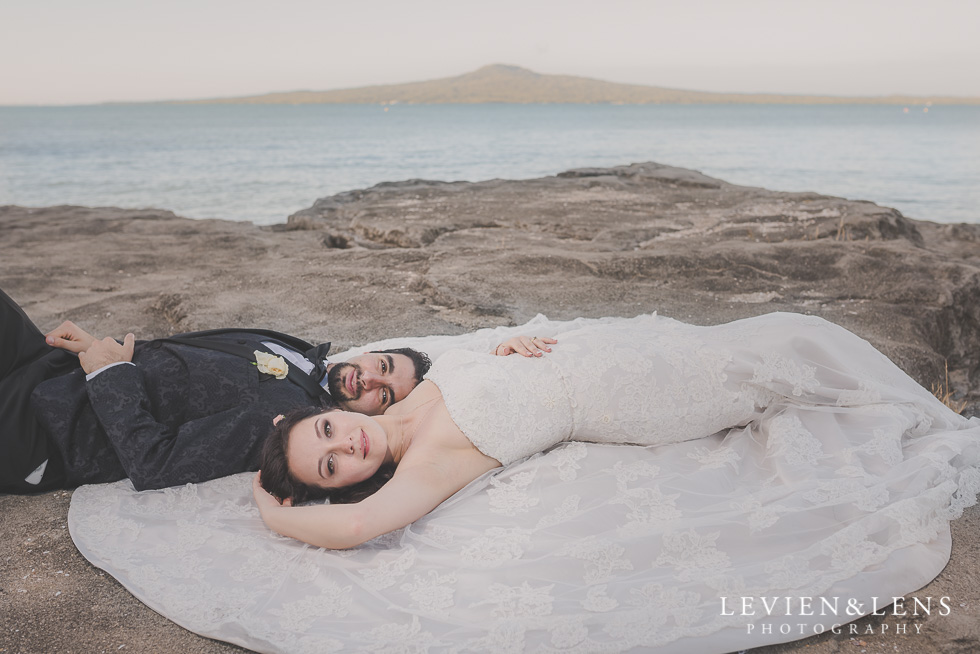 bride groom laying cliff St Heliers beach {Auckland-Hamilton-Tauranga wedding photographer}