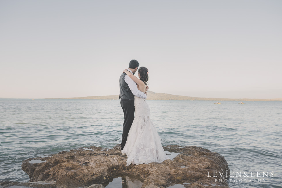 bride and groom look at ocean back St Heliers beach {Auckland-Hamilton-Tauranga wedding photographer}