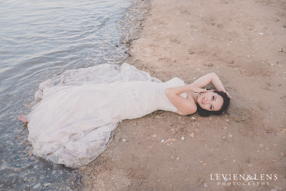 gorgeous bride laying sand St Heliers beach {Auckland-Hamilton-Tauranga wedding photographer}