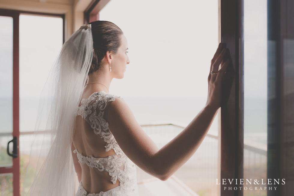 bride near window Castaways Resort - Kariotahi beach wedding {Auckland lifestyle couples-engagement photographer}