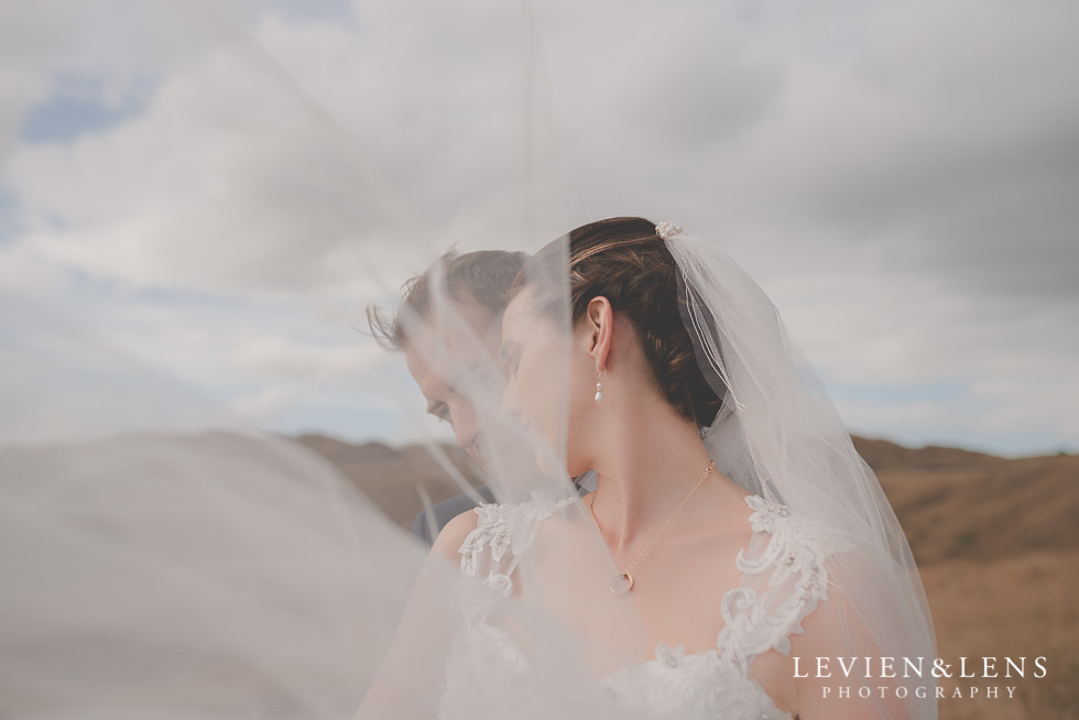 windy veil bride groom location shoot Kariotahi beach Castaways {Auckland wedding-engagement-couples photographer}