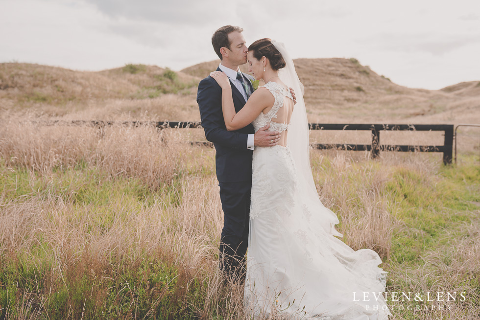 bride groom forehead kiss - location shoot Kariotahi beach Castaways {Auckland wedding-engagement-couples photographer}