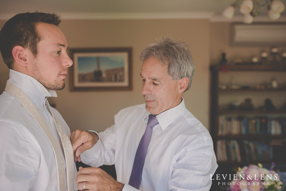 father helping groom getting ready {Auckland-Hamilton-Tauranga wedding photographer}