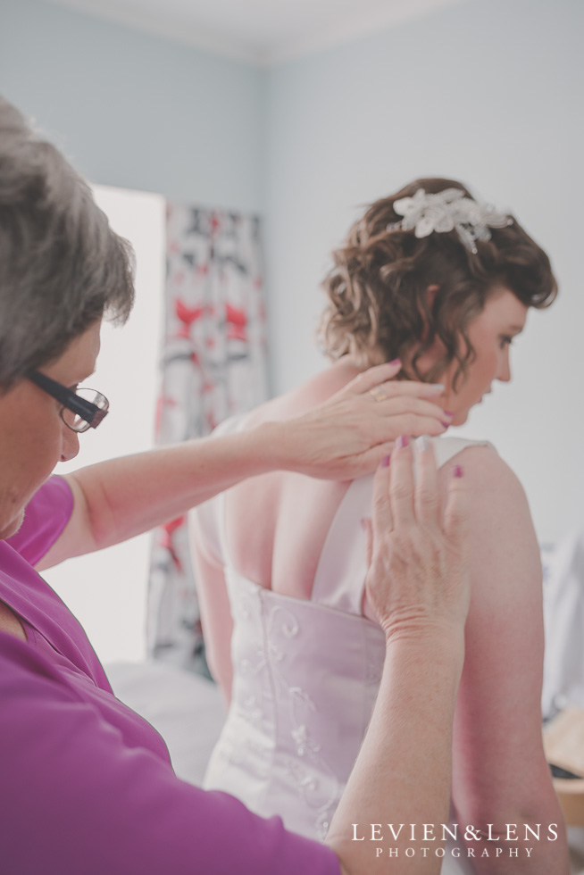 mother helping bride with dress {Auckland-Hamilton-Tauranga lifestyle wedding-couples-engagement photographer}