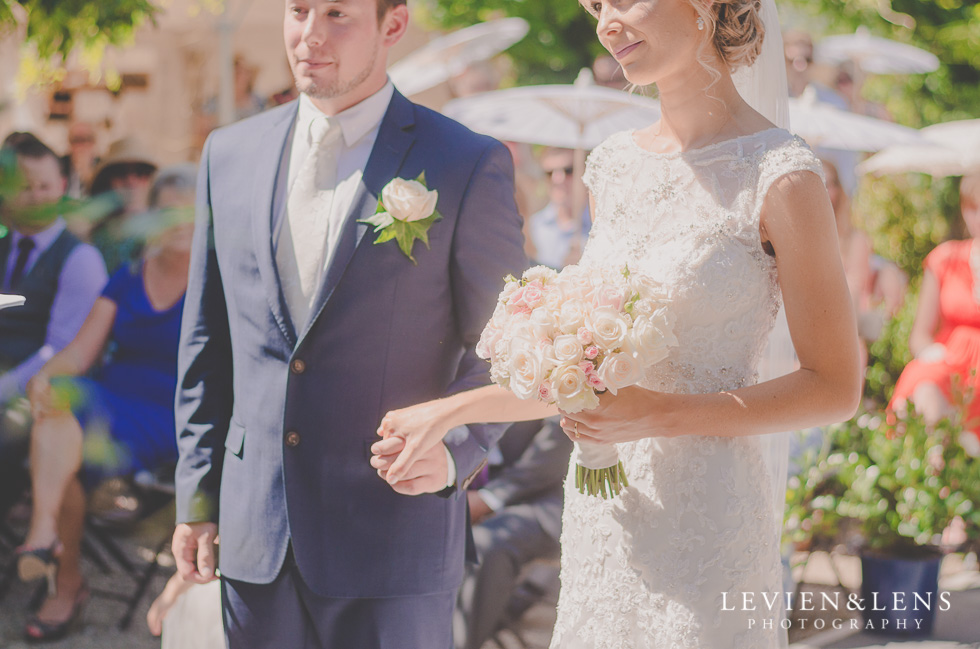 bride and groom holding hands {Tauranga-Bay of Plenty wedding-couples-engagement photographer}