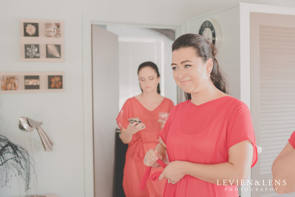 bridesmaids watching bride getting ready Kaurilands Estate {Auckland wedding photographer}