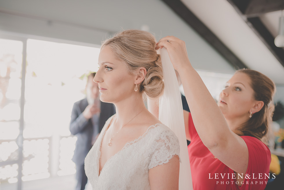 putting veil on bride getting ready Kaurilands Estate {Auckland wedding photographer}