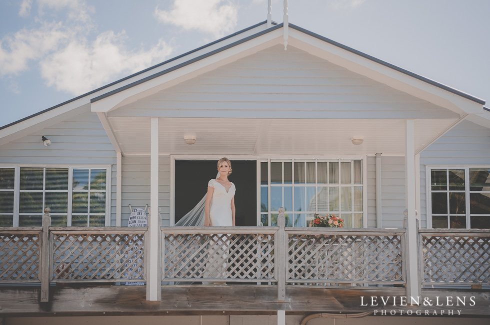 bride standing on balcony bride getting ready Kaurilands Estate {Auckland wedding photographer}