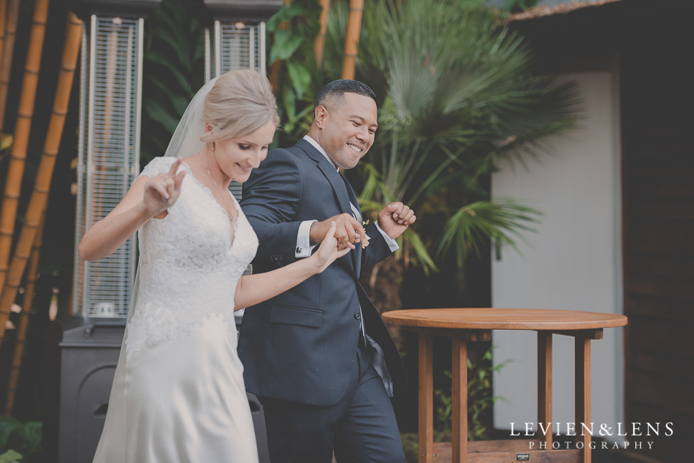 bride and groom enter reception Landscendt Tropical Garden {Auckland wedding photographer}