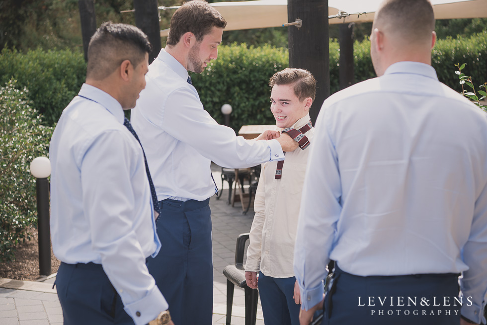 groomsmen putting tie on Brigham - Herald Island {Auckland lifestyle wedding photographer}