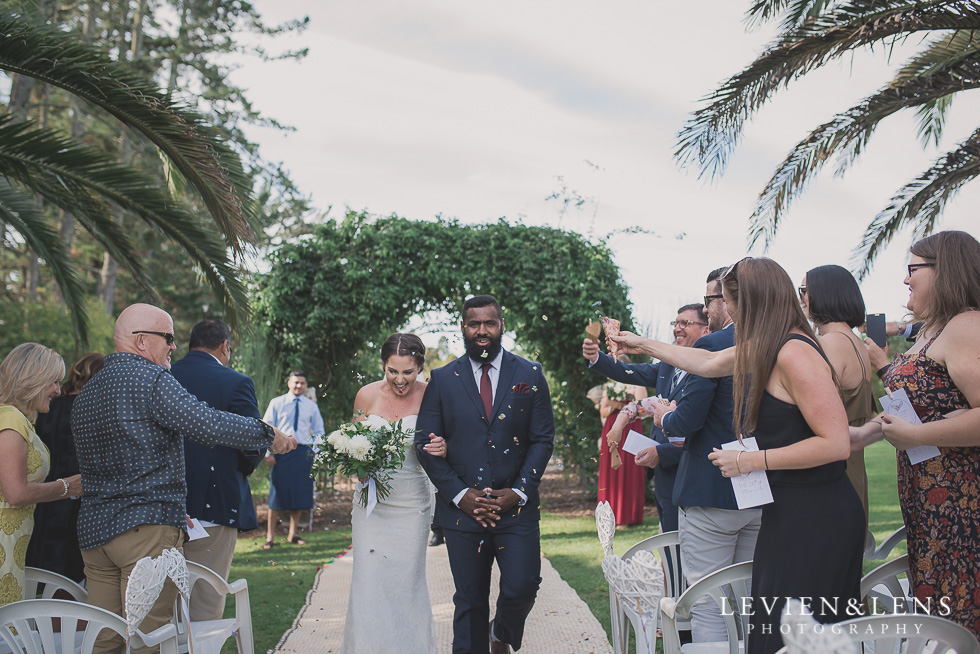 bride and groom walking aisle Brigham - Herald Island {Auckland lifestyle wedding photographer}