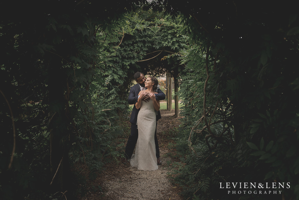 bride and groom in garden tunnel Brigham - Herald Island {Auckland lifestyle wedding photographer}