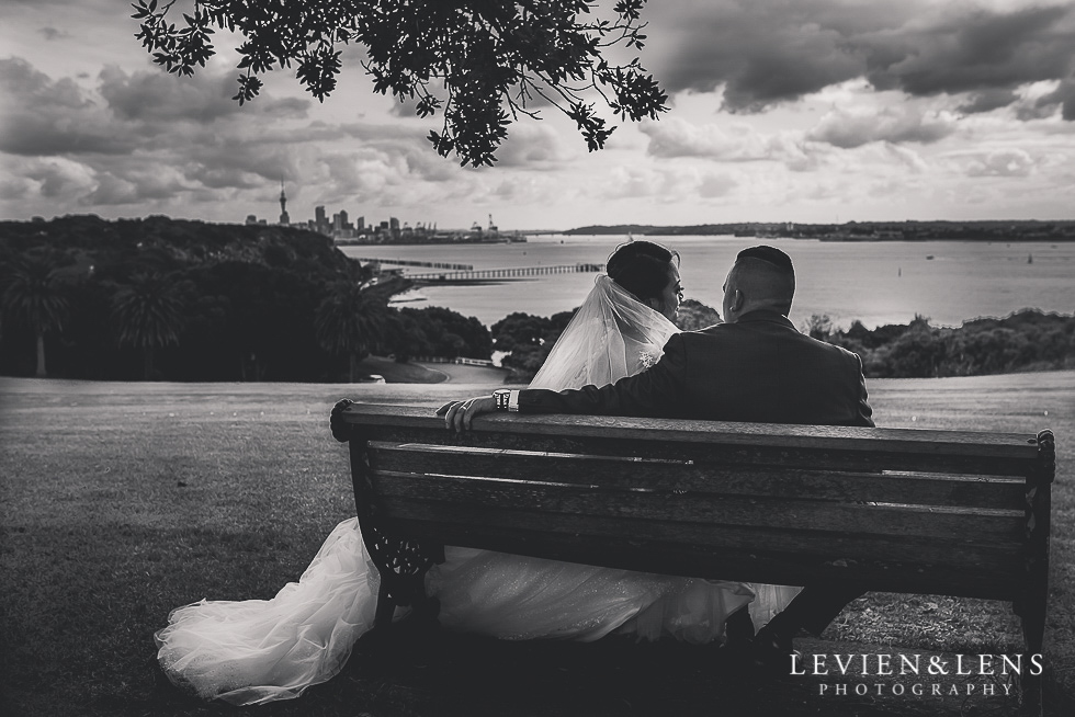 bride and groom sitting on bench Church Of The Holy Sepulchre - Bastion Point {Auckland NZ lifestyle wedding-engagement photographer}