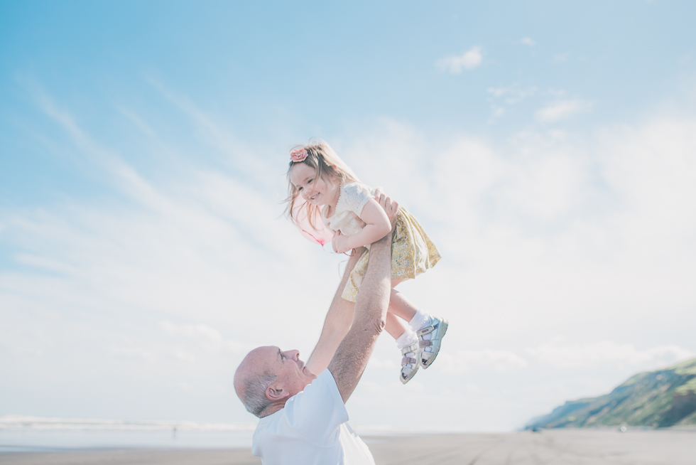 dad holding daughter - Kariotahi beach photo shoot {Auckland lifestyle family-kids photographer}