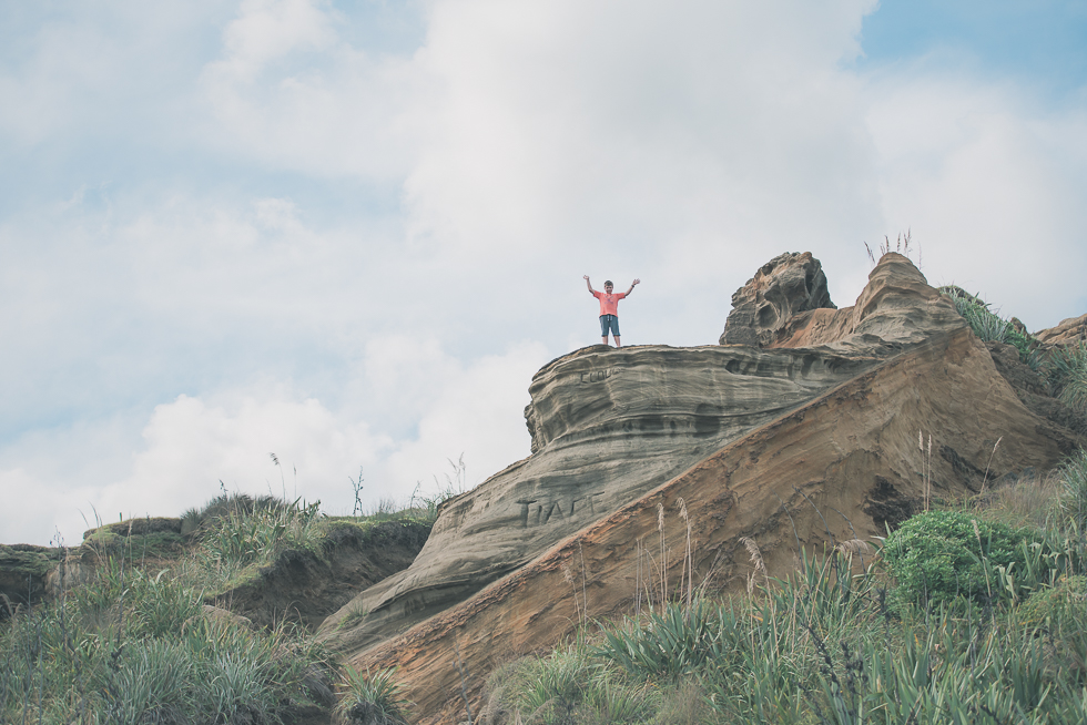 boy on cliff - Kariotahi beach photo shoot {Auckland lifestyle family-kids photographer}