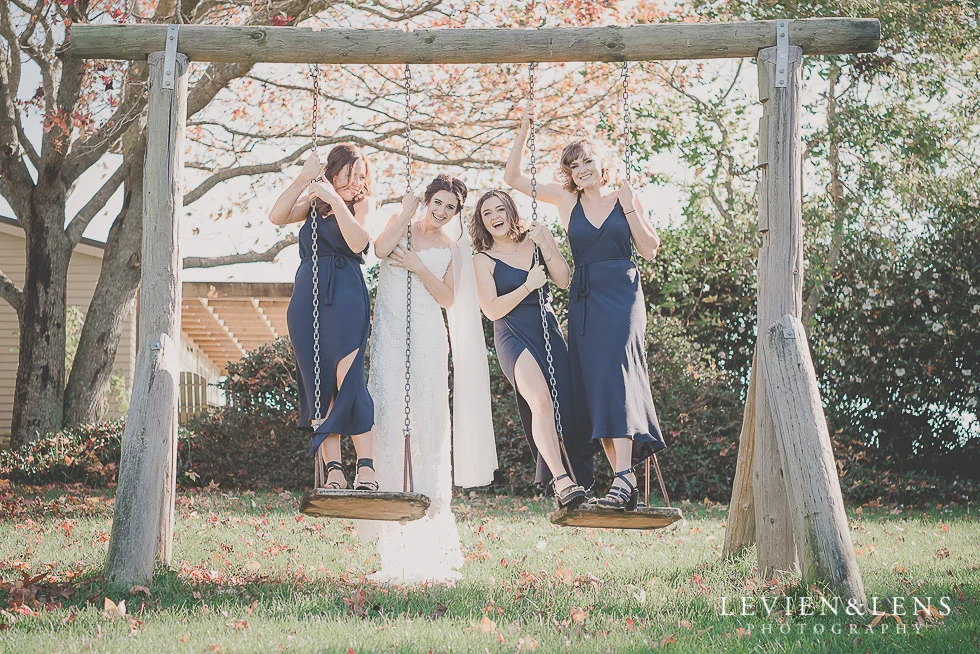 bride with bridesmaids on swing St Margarets Cafe - Karaka {Auckland lifestyle wedding photographer}