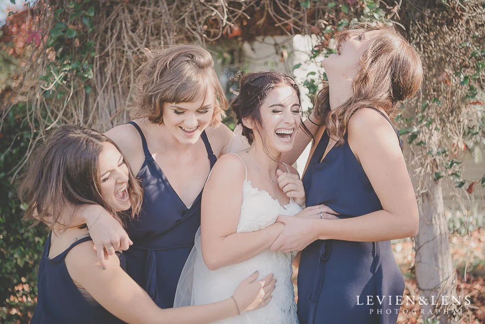 bride with bridesmaids laughing St Margarets Cafe - Karaka {Auckland lifestyle wedding photographer}