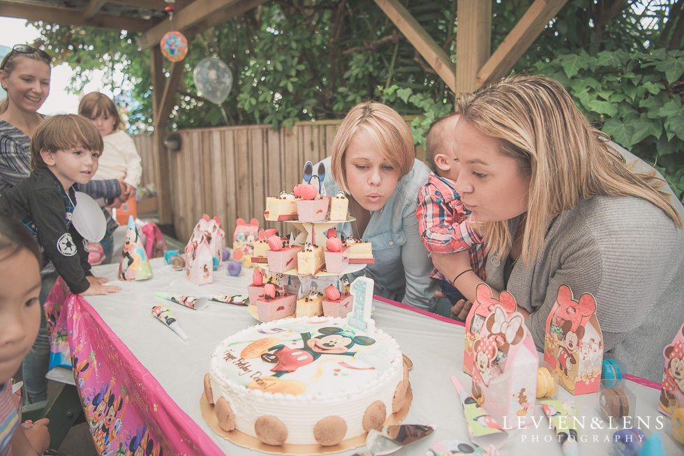 blowing candle - Rainbows End birthday party {Auckland lifestyle event-family-kids photographer}