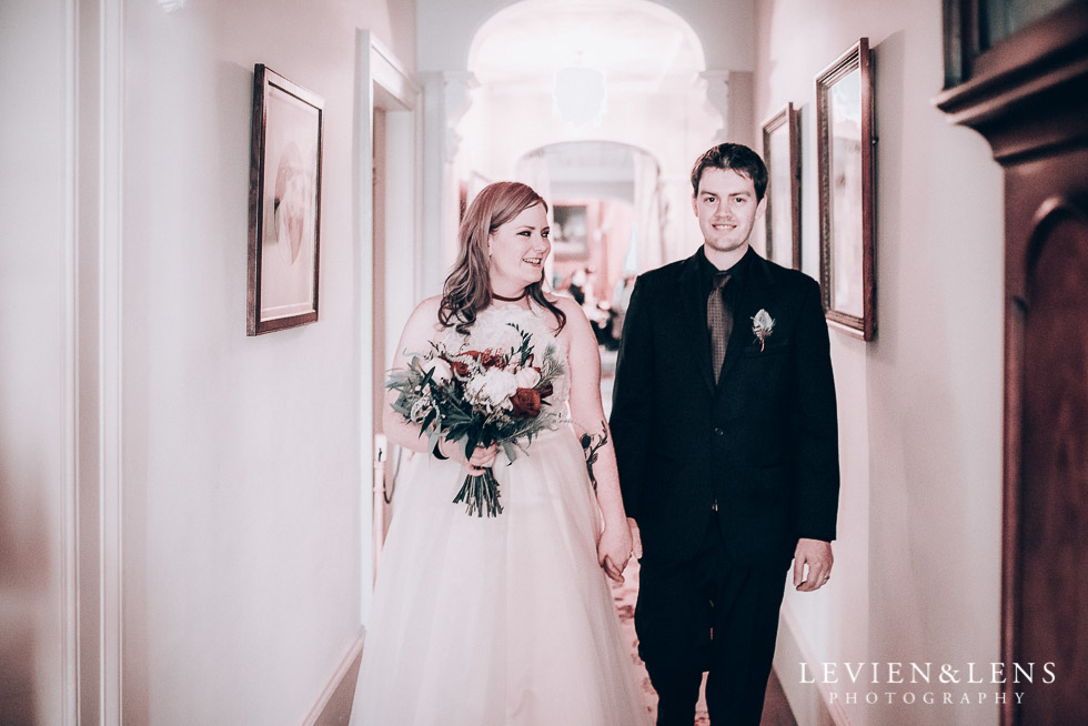 bride and groom walking at aisle - Highwic historic house-museum winter wedding {Auckland NZ lifestyle weddings photographer}