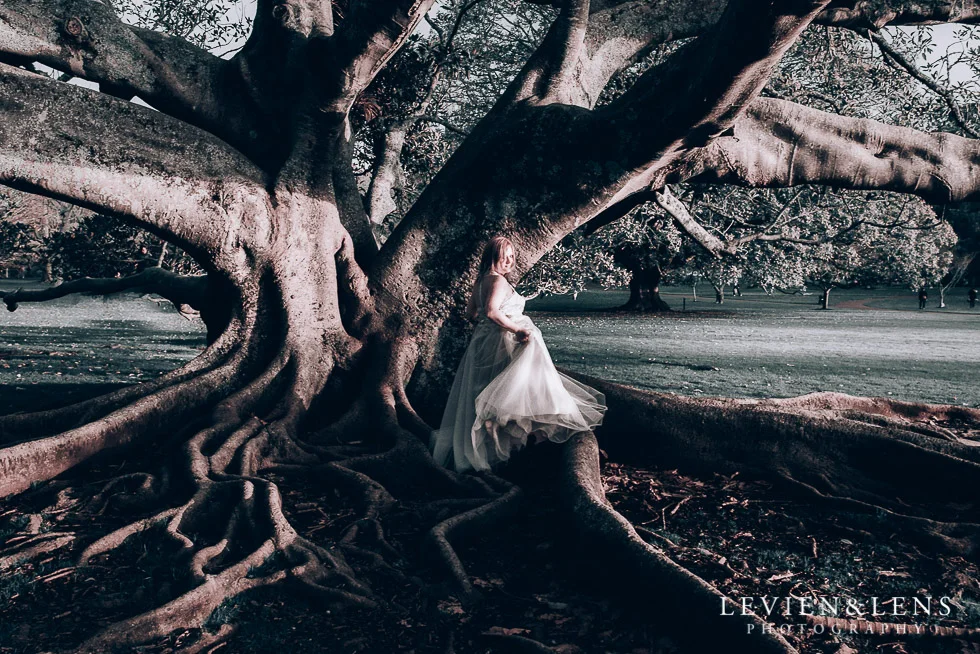 bride near big tree - Cornwall park photo session - winter wedding {Auckland NZ lifestyle weddings photographers}
