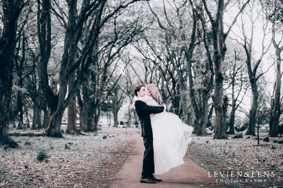 bride and groom twirl at alley - Cornwall park photo session - winter wedding {Auckland NZ lifestyle weddings photographers}