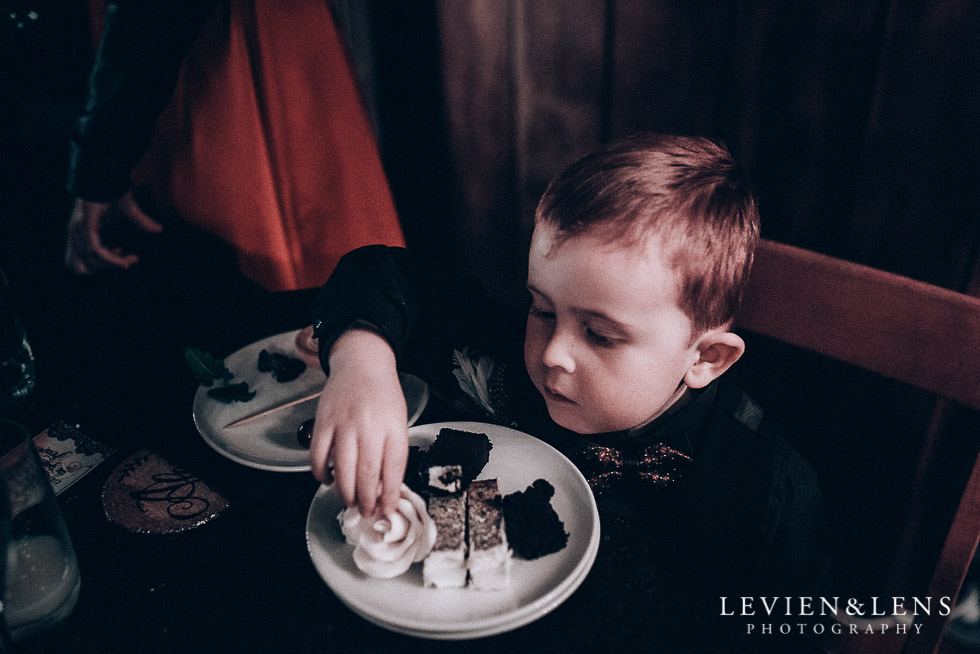 boy - ring bearer trying cake - Highwic historic house-museum winter wedding {Auckland NZ lifestyle weddings photographer}