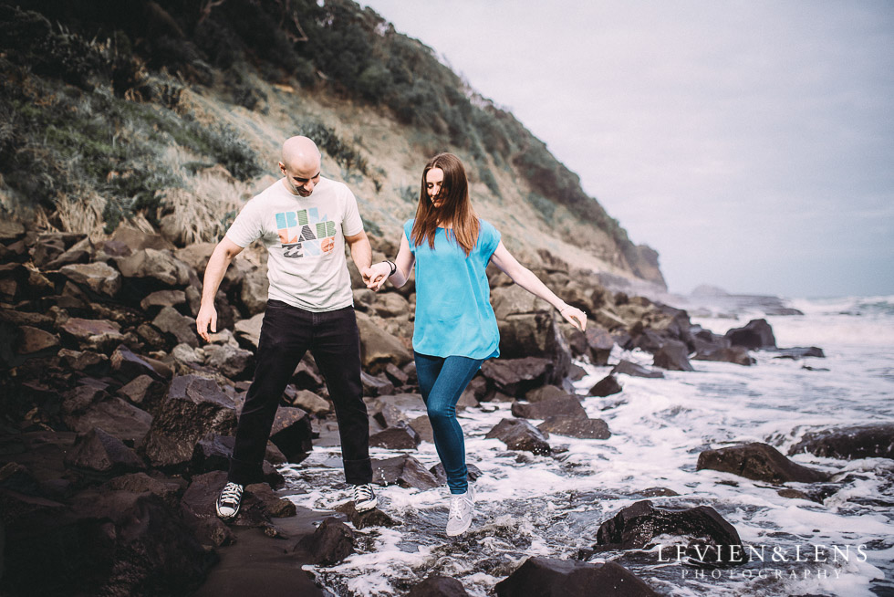 jump in the waves {Auckland couples-engagement photographer} Muriwai beach