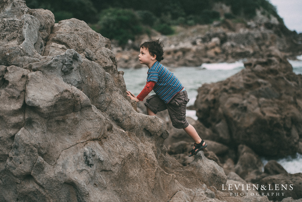 boy climbing on cliff - One little day in Tauranga - personal everyday moments {Hamilton NZ wedding photographer} 365 Project