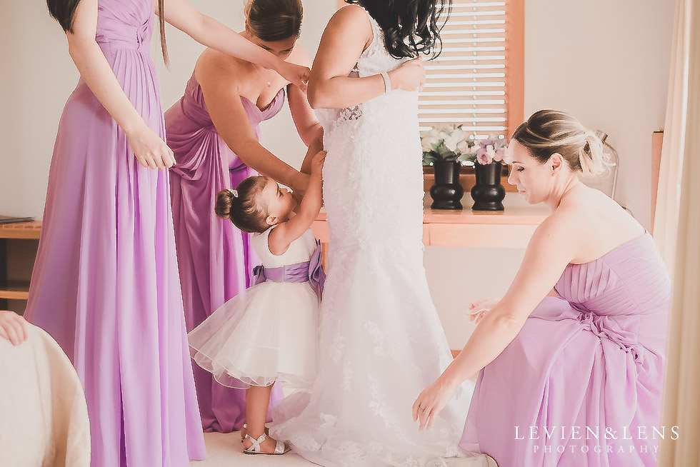 bride getting ready - put dress on - Formosa wedding Golf Resort {Auckland weddings photographer}