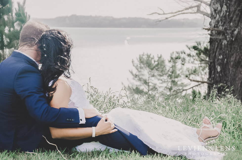 bride and groom sitting at the beach - Formosa wedding Golf Resort {Auckland weddings photographer}