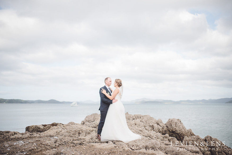 bride groom on rocks - edge - The Duke of Marlborough Hotel - Russel wedding {Northland-New Zealand weddings photographer} beach