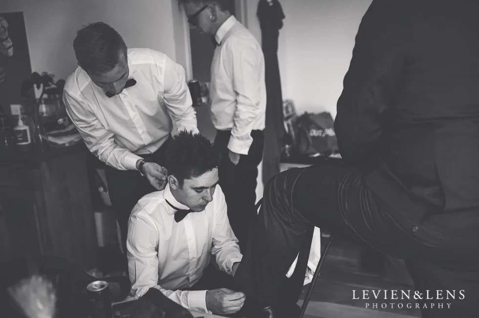 groom with groomsmen getting ready - New Zealand wedding photographer