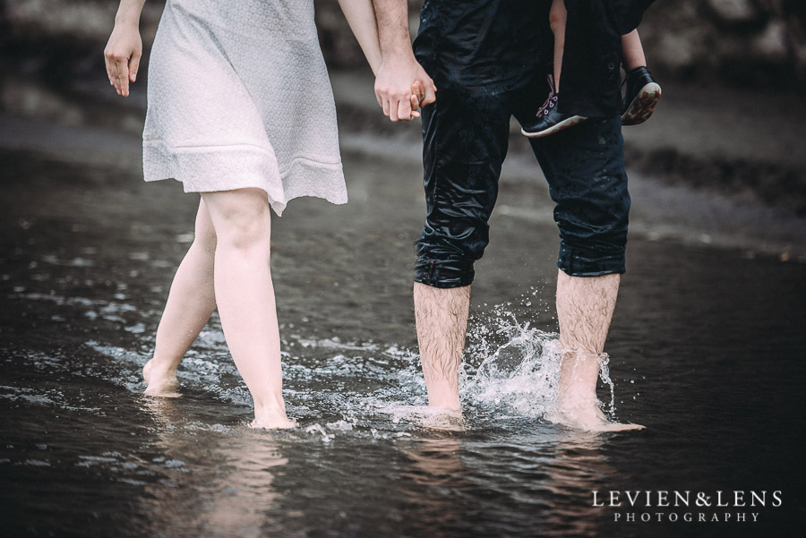 couple walking in water - Karekare Beach post-wedding | elopement photo shoot {Auckland NZ couples-weddings photographer}