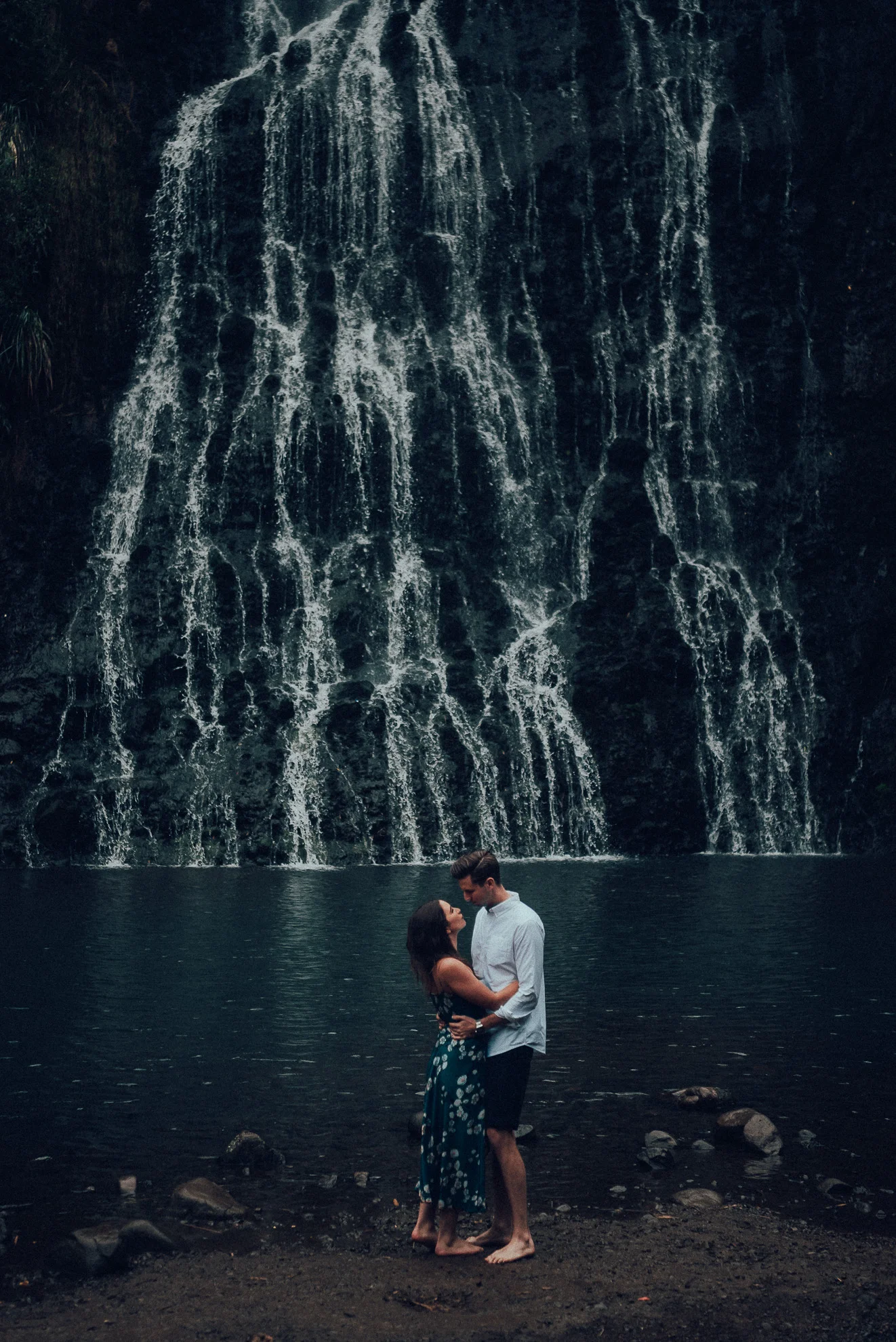 couple hug romantic moment at Karekare falls {West Auckland wedding photographers}