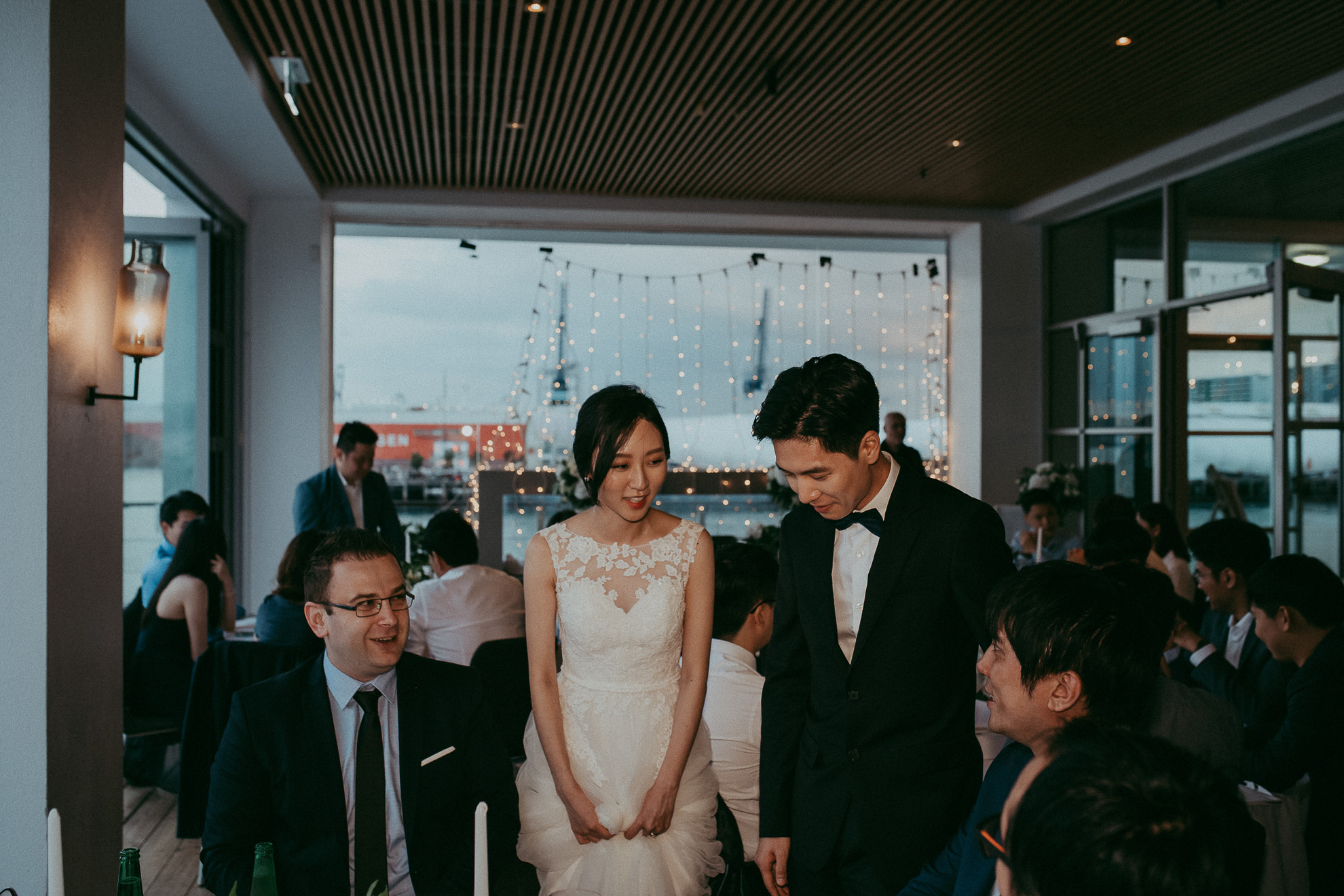 bride and groom at reception with guests 