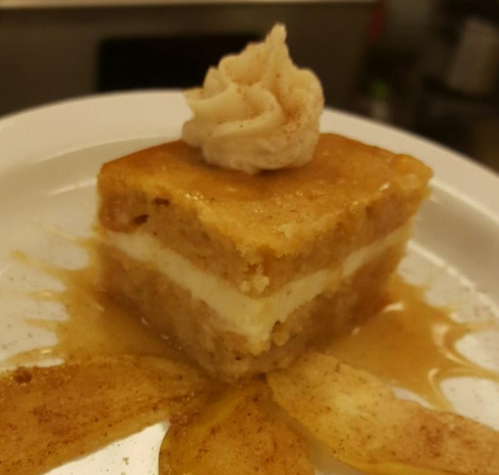 Apple cake with 5-spice cream cheese frosting, served over spiced baked apples drizzled with apple caramel sauce. 
