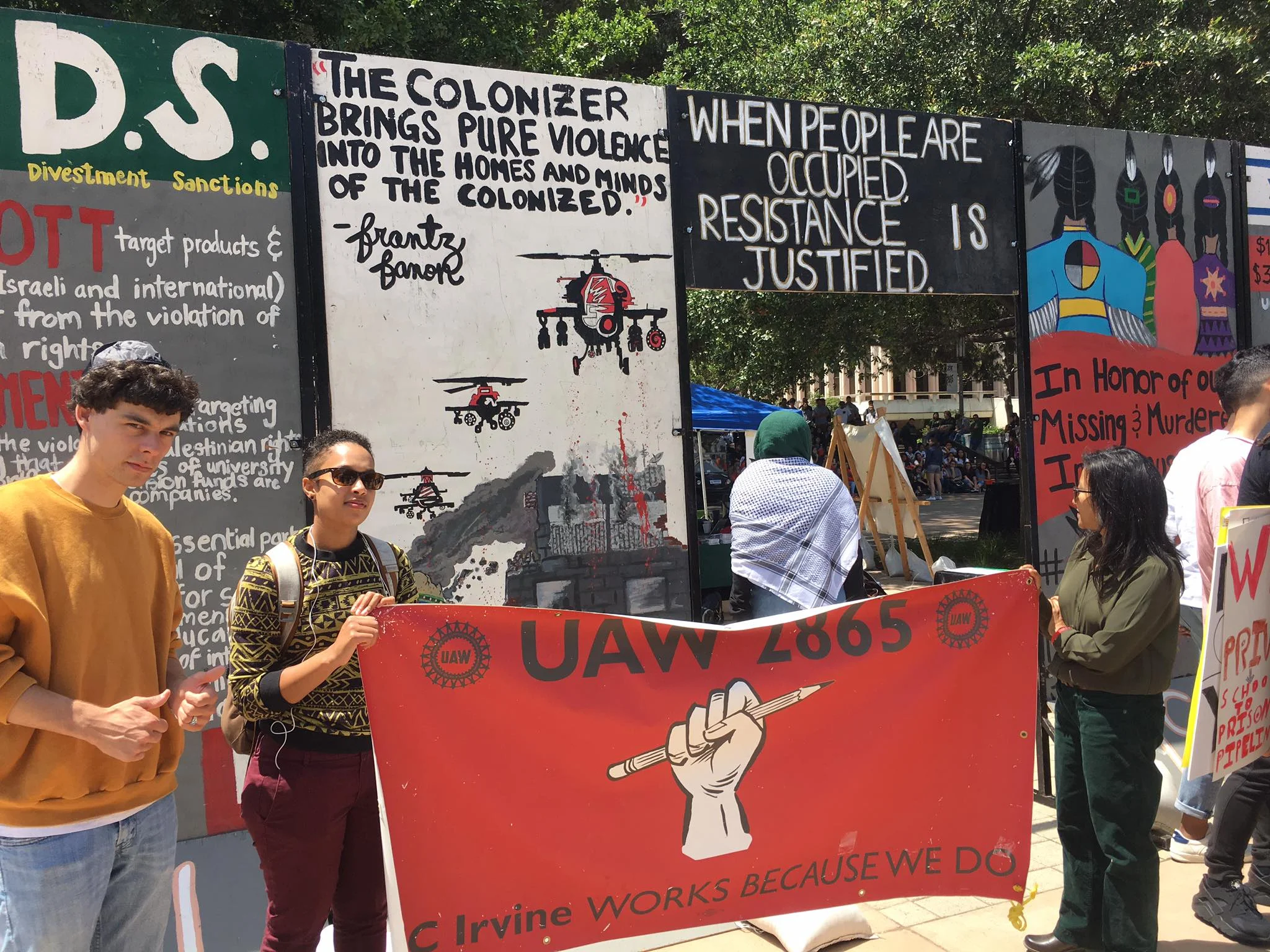 A mock apartheid wall at UC Irvine. The man in the kippa, an SJP and JVP member, was told multiple times by soldiers to remove his kippa and that he was not a real Jew.