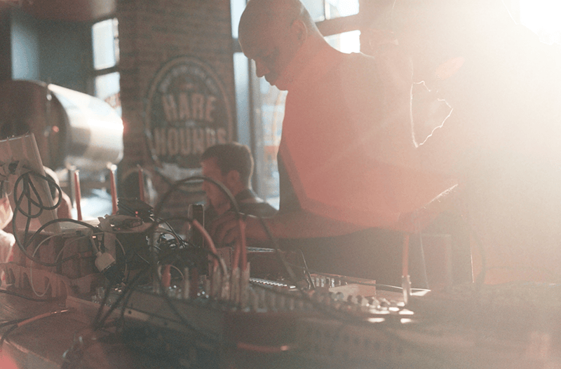     Obscured by sun and cables; Atomico on hardware-triggered visuals with Electric Ape behind the wires at the Brighton launch for Euphony In Electronics / 1.1 at Hare & Hounds. 