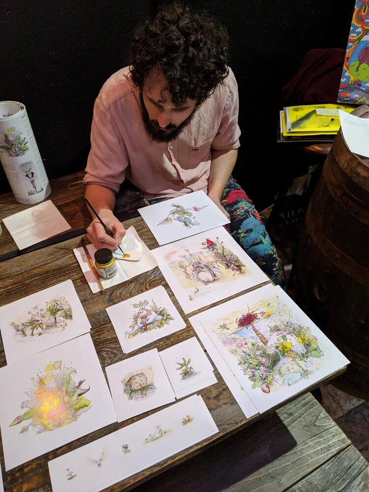 Rodrigo’s artwork proudly on display, caught here hand-highlighting his prints.