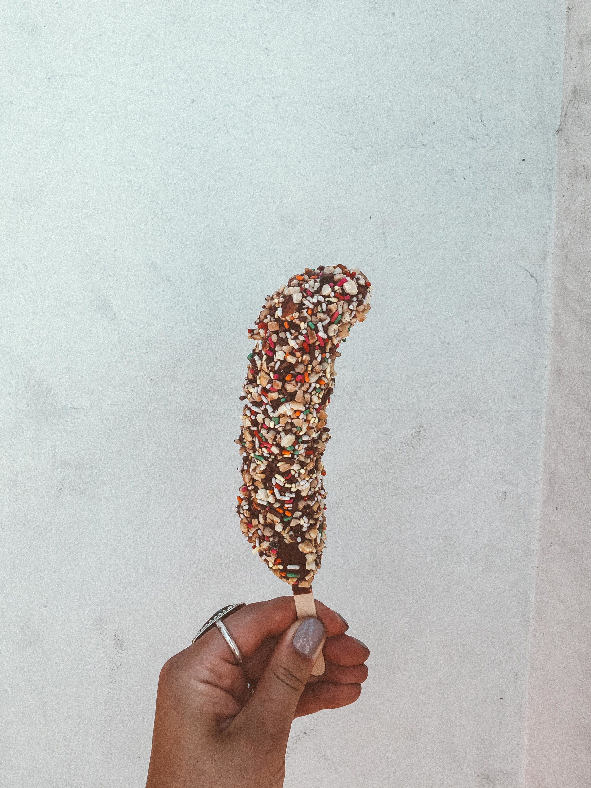 * this is a frozen banana, dipped in chocolate, and covered in rainbow sprinkles
