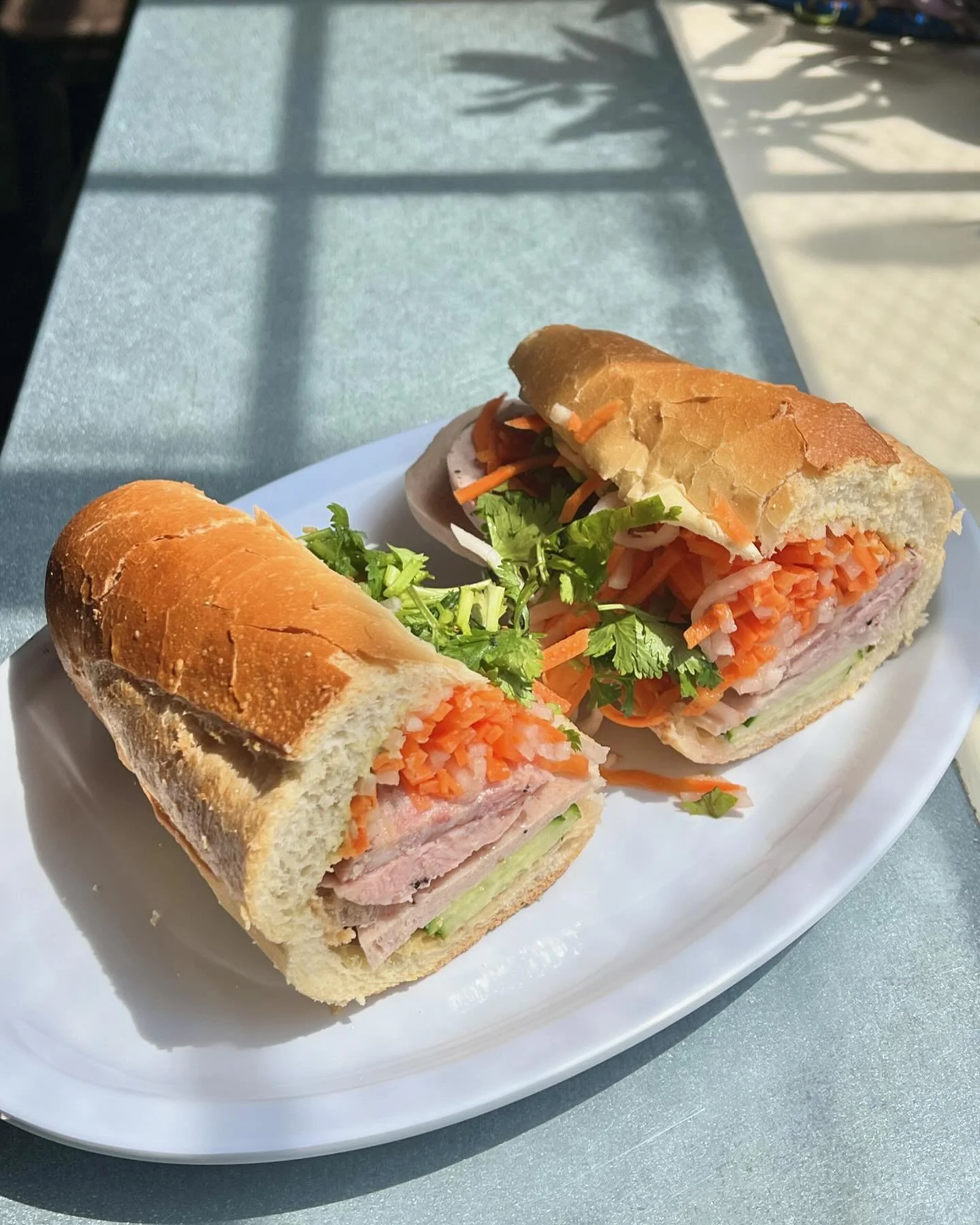 behold, if u will, the b&aacute;nh m&igrave; classic: two styles of Vietnamese ham, house-made chicken liver p&acirc;t&eacute;, requisite pickled carrot &amp; daikon, cilantro and fancy mayo on a @grimaldibakery 🥖 baguette. cut expertly into (2) hal