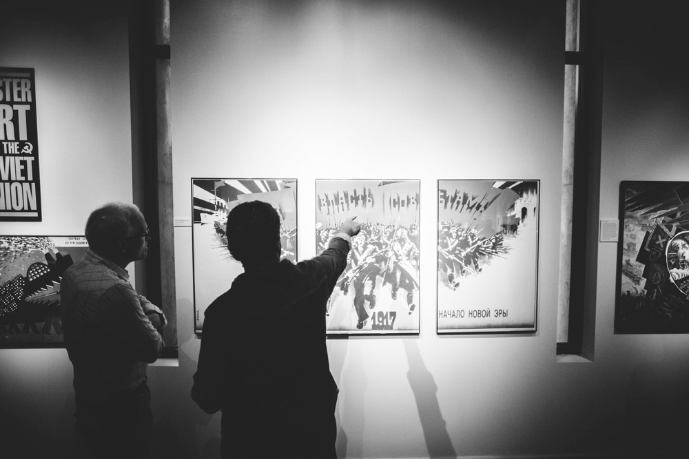 Viewers in front of Sachkov's 1988 triptych poster "All Power to The Soviets." Photo : Edward Honaker