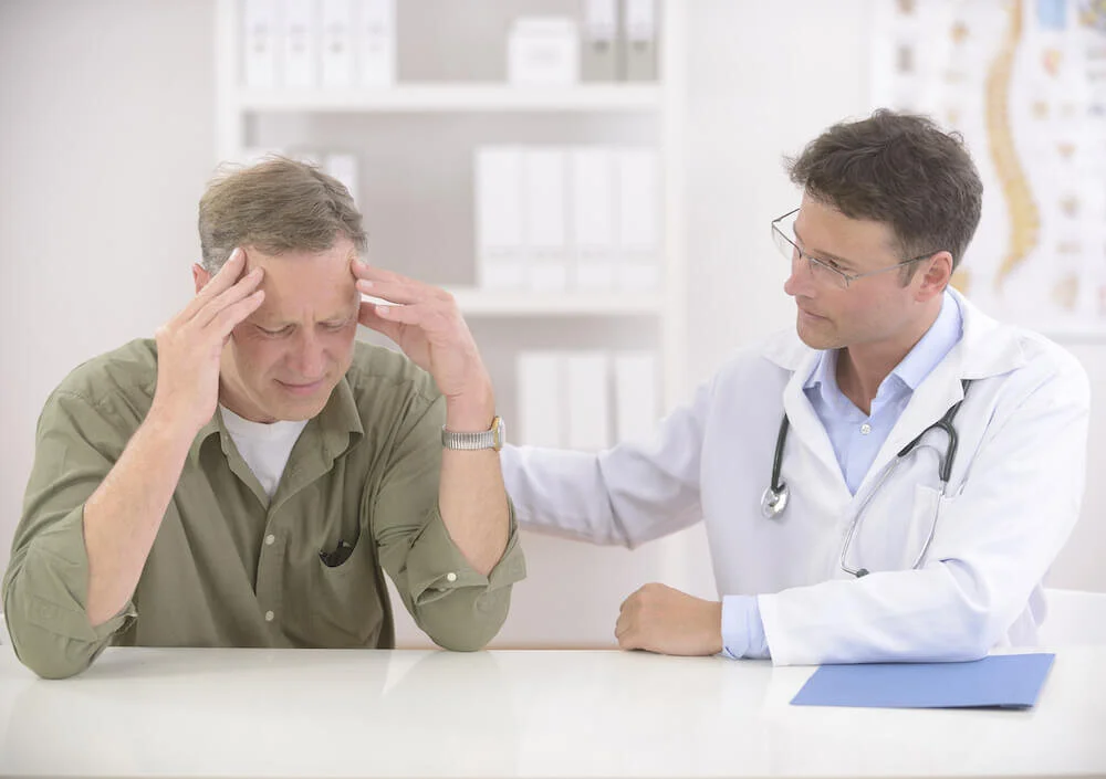 Doctor-comforting-mature-stres-34176719.jpg