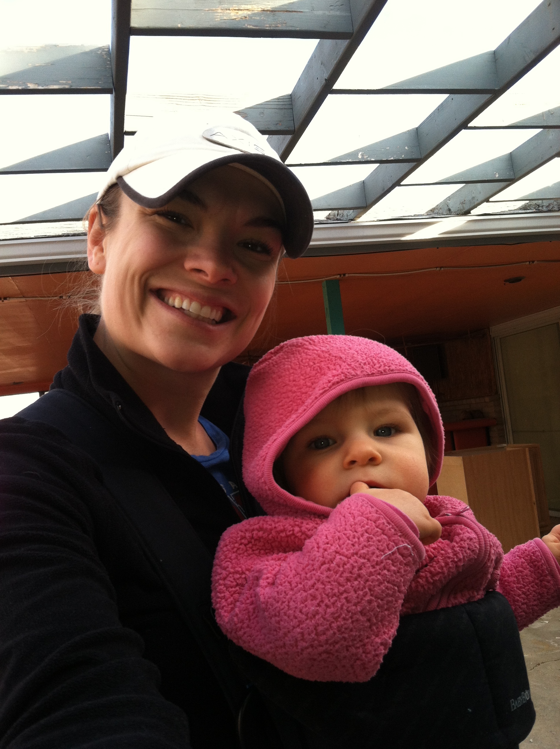 Tia (11 months) and I while project managing our house (also, notice the Tiki bar in the back corner!) 