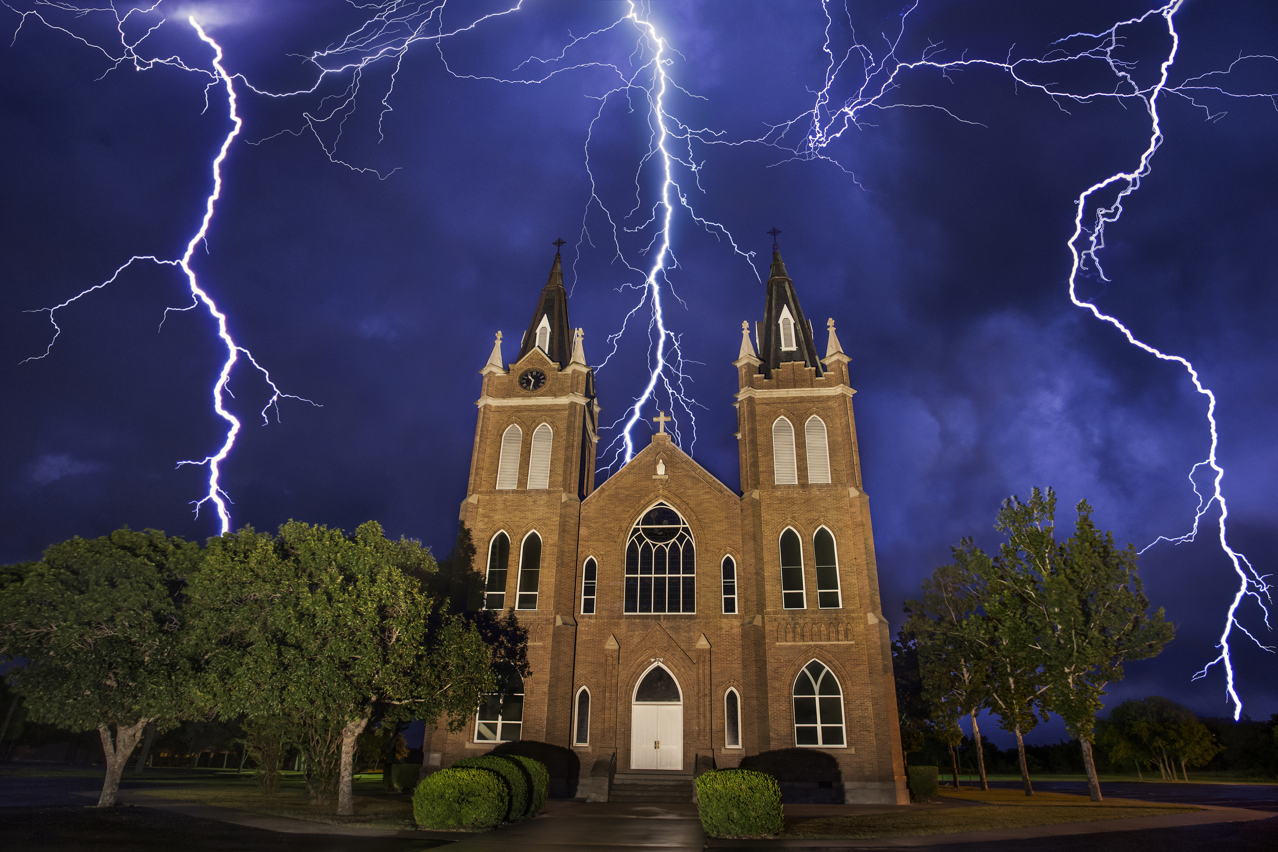  Lightning behind the Holy Trinity Church in Schwertner, Texas Stacked image of 4 photos.&nbsp; 