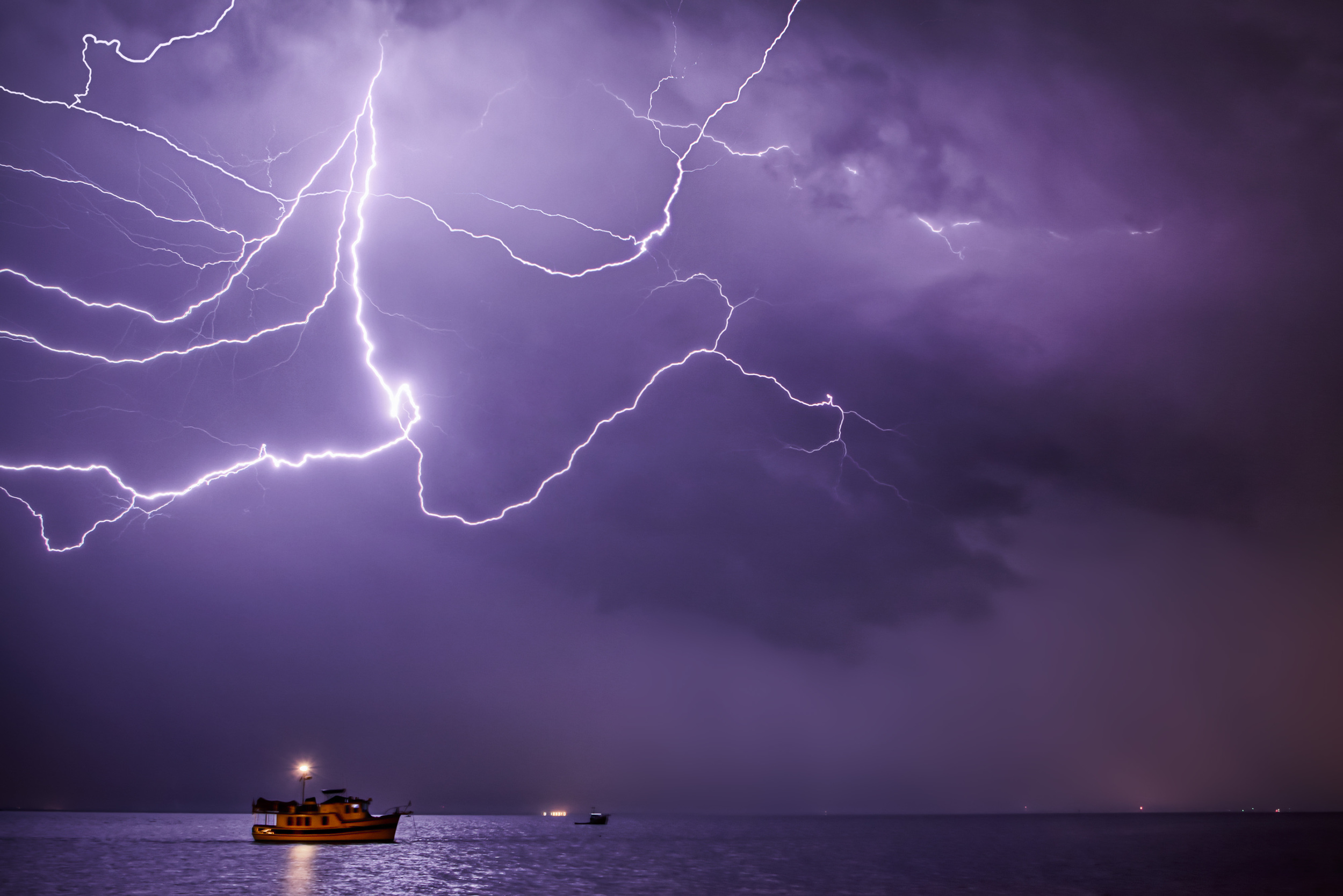   Cloud to cloud lightning over a boat in the Indian River, in Titusville, Florida  