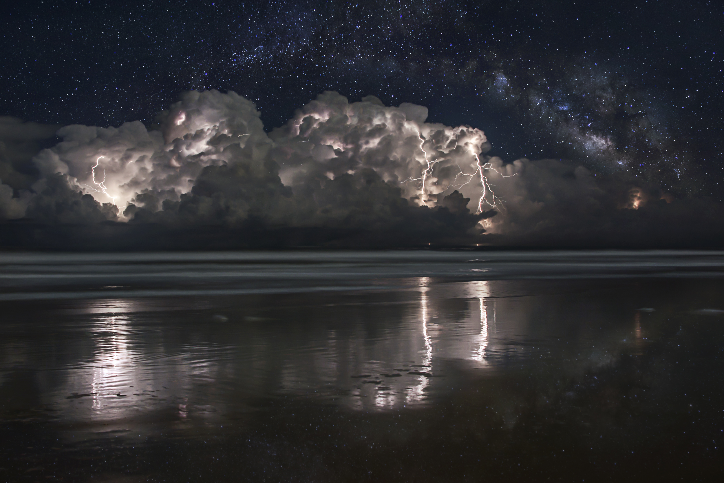  Cluster of storms off the coast of Ormond Beach, Florida with the Milky Way composited behind them on October 11, 2012. 4 image stack for lightning. 8 image panorama for Milky Way.&nbsp; 